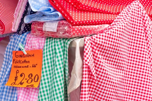 Selection of multicoloured gingham cloths for sale at a UK market