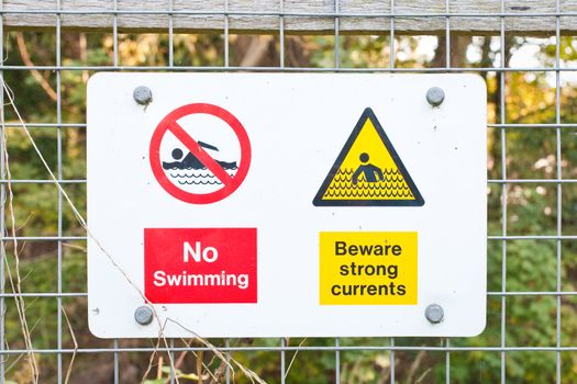 A sign warning against swimming beside a river in England