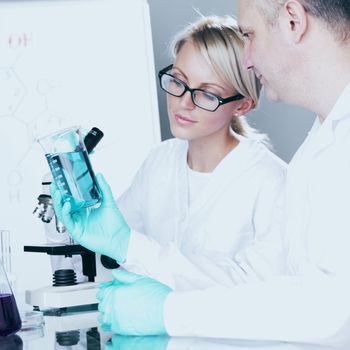  two scientist in chemical lab conducting experiments