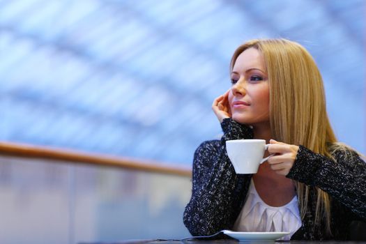  young woman drink coffee on modern background