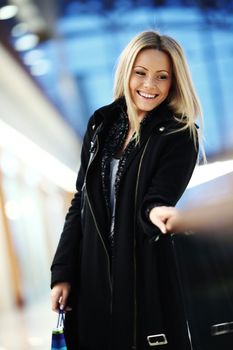 woman in shop center holds the bag in hands