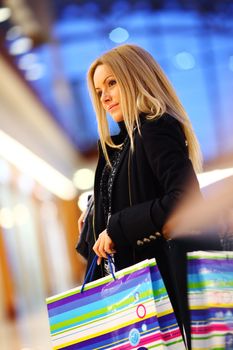 woman in shop center holds the bag in hands