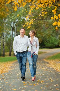 Romantic happy young beautiful couple on autumn walk