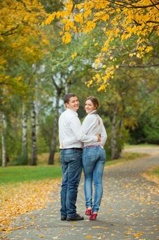 Romantic happy young beautiful couple on autumn walk. Vertical view