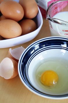 Eggs and milk on the table, preparation for cooking