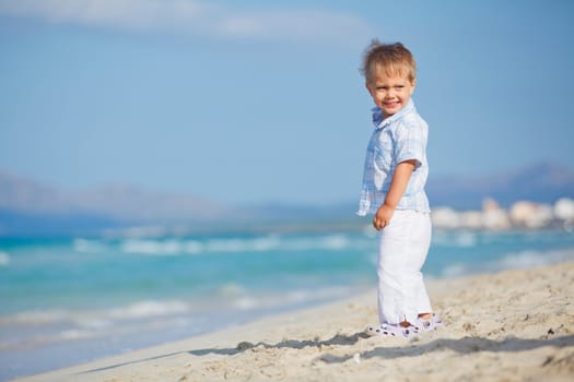 Little cute boy on the beautiful exotic white beach, Mallorca, Spain