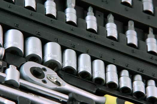 detail from black case of tools set with variate of bit sockets industrial and construction equipment