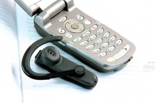 cell phone detail with hands free on diary communication concepts