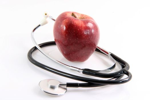 healthy food red apple and phonendoscope health and medical objects isolated on white background