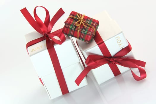 one small tiny gift box with two white gift boxes with red ribbon for valentines day and love gifts shopping concepts