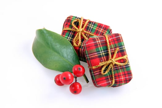 christmas pressents with two small gift boxes and christmas berries isolated