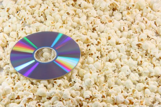 dvd disc movie on pop corn background food and entertainment conceps