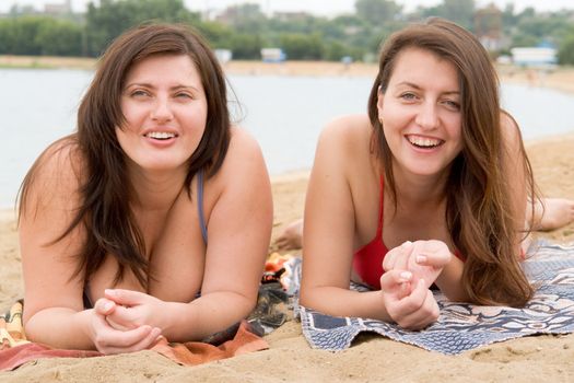 Two young pretty women on a beach