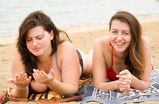 Two young pretty women on a beach