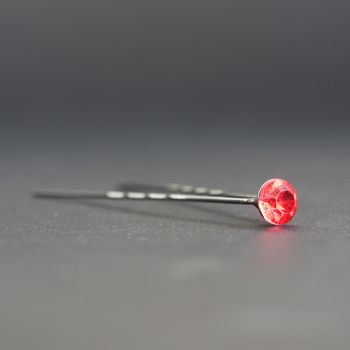 Hairpin with a ruby on a grey background