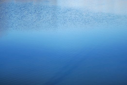 reflections of sunrays are in off-shore waves, shiny blue waves