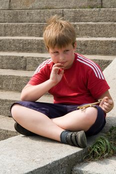 The little boy with the toy lizard in hands