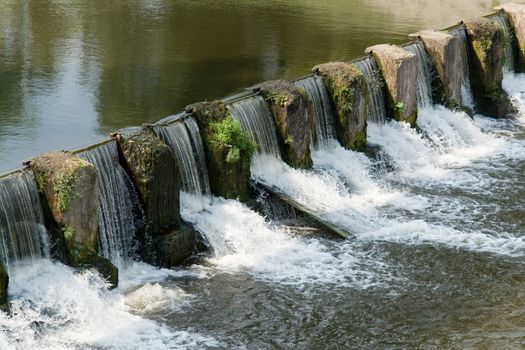 the cascade. Overflow dam on small river