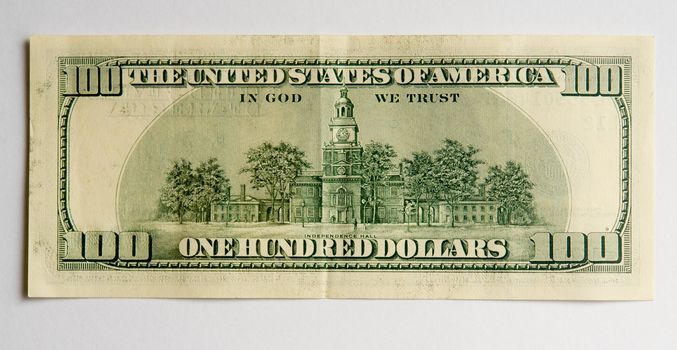 hundred dollar bill on a grey background