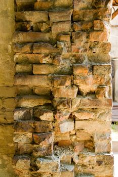 the brickwork. An ancient, weathered brick wall