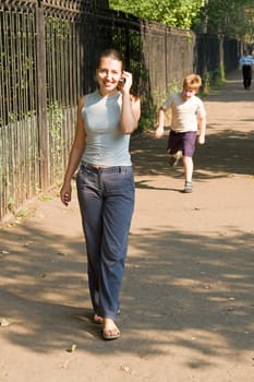 girl with mobile phone In a summer park