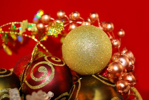Gold Christmas ornaments and other decor are on the red. 