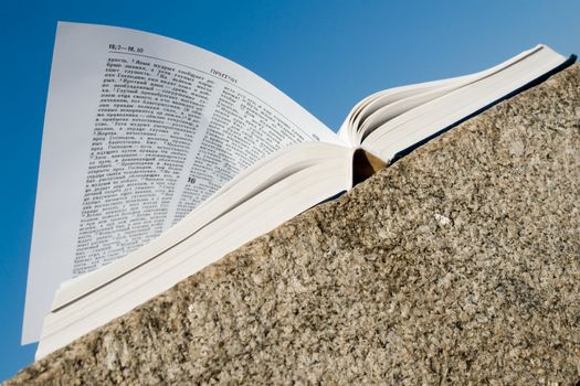 Holy Bible. The open book with sky at background