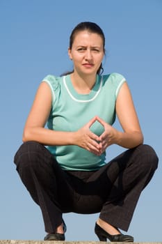 beautiful girl sits on a blue sky