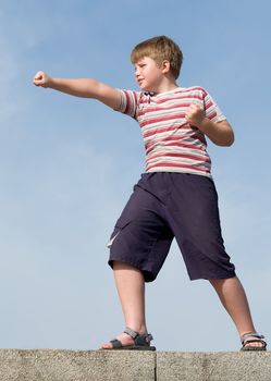 fighter boy with blue sky at background