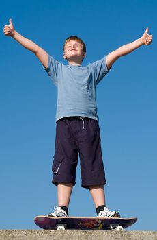 boy with skateboard on a blue sky