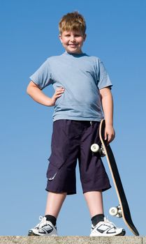 boy with skateboard on a blue sky