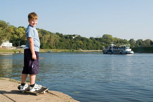 boy on a skateboard with river at background
