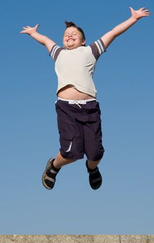 jumping boy with blue sky at background