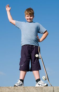 boy with skateboard on a blue sky
