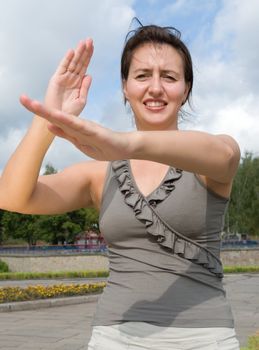 karate. fighter woman with blue sky at background