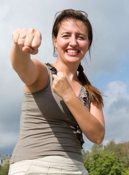 karate. fighter woman with blue sky at background