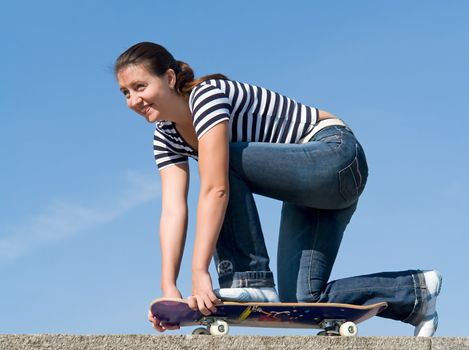 girl on a skateboard with blue sky at background