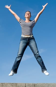 jumping girl with blue sky at background
