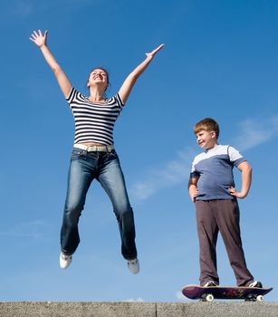 jumping family with blue sky at background