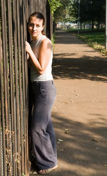 portrait of a beautiful woman near a fence