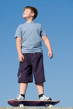 boy with skateboard on a blue sky