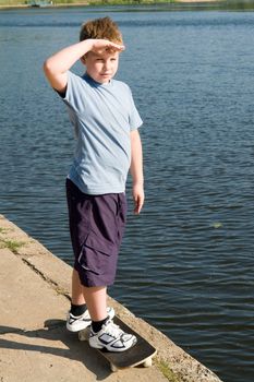 boy on a skateboard with river at background