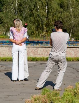 Young kissing couple. Before wedding video shooting.