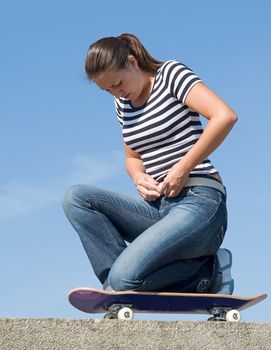 girl on a skateboard with blue sky at background