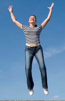 jumping woman with blue sky at background