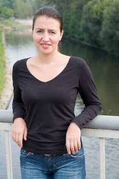 portrait of a beautiful woman with river at background