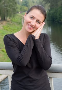 portrait of a beautiful woman with river at background