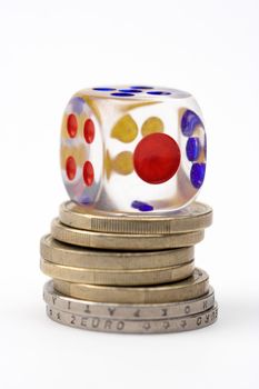 Dice on stack of coins,close up,over white