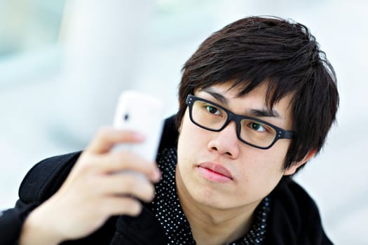 young man taking picture with mobile phone