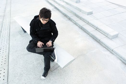 man using computer outdoor